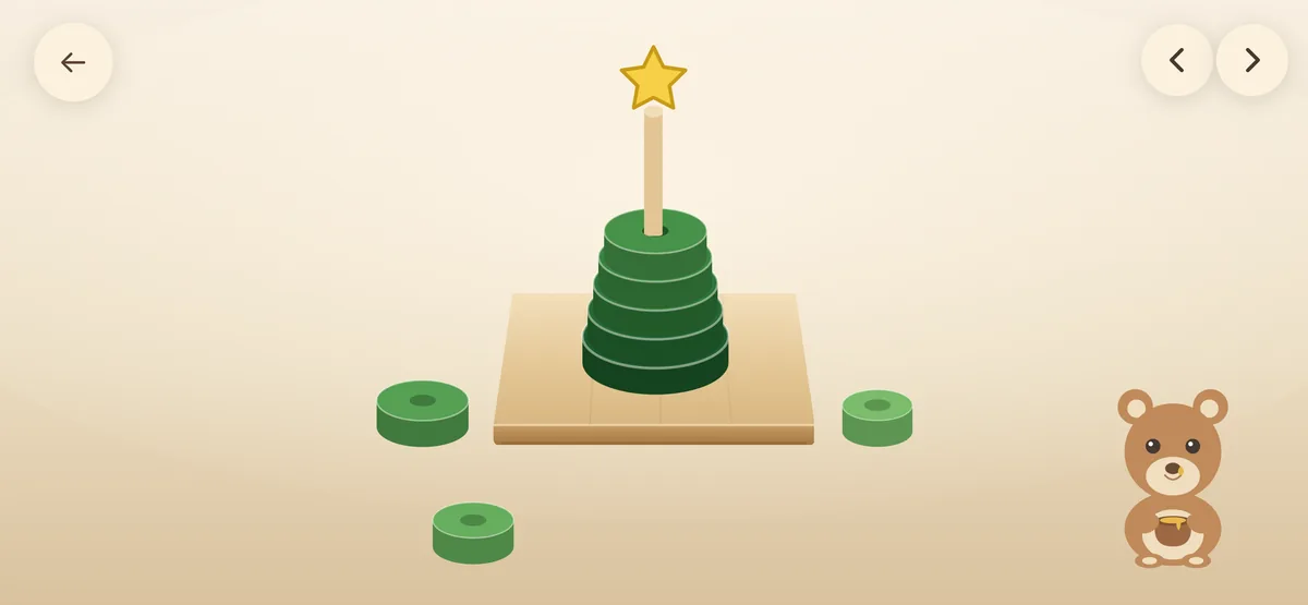 A green tower of rings topped with a golden star, three rings still to add