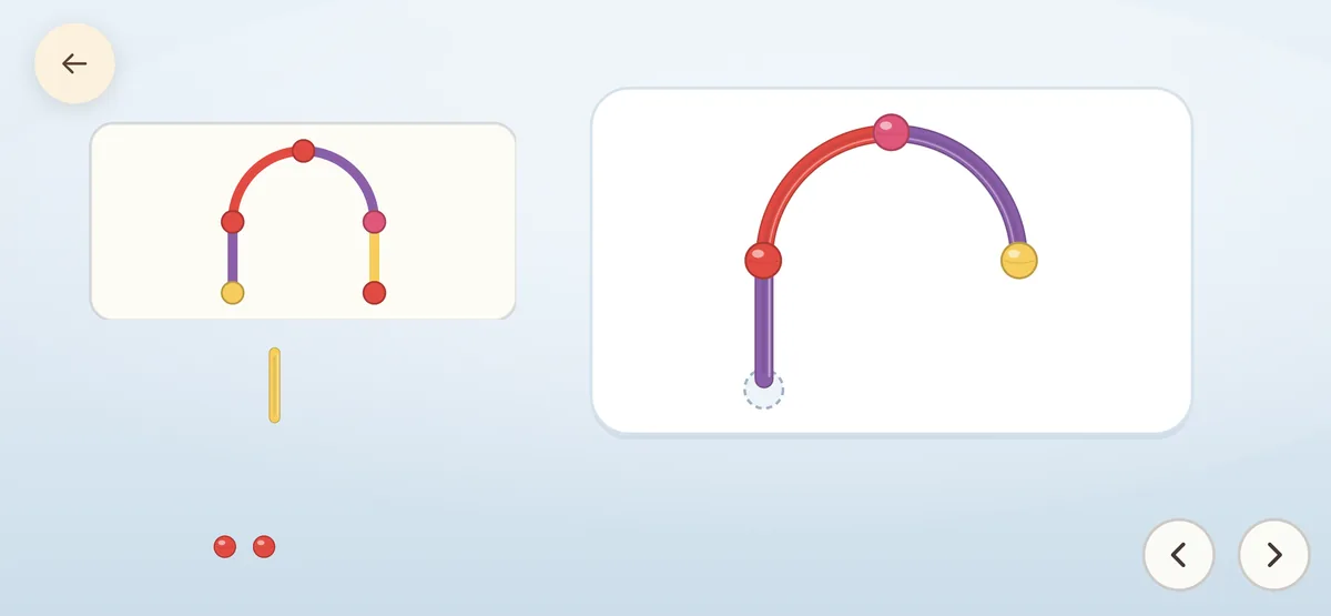 A red and purple arch of sticks with one joint still missing